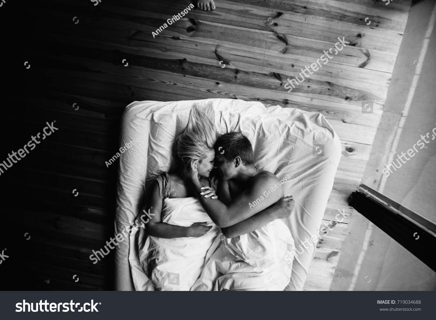 Young romantic couple in love have fun and hugs in the white bed love and