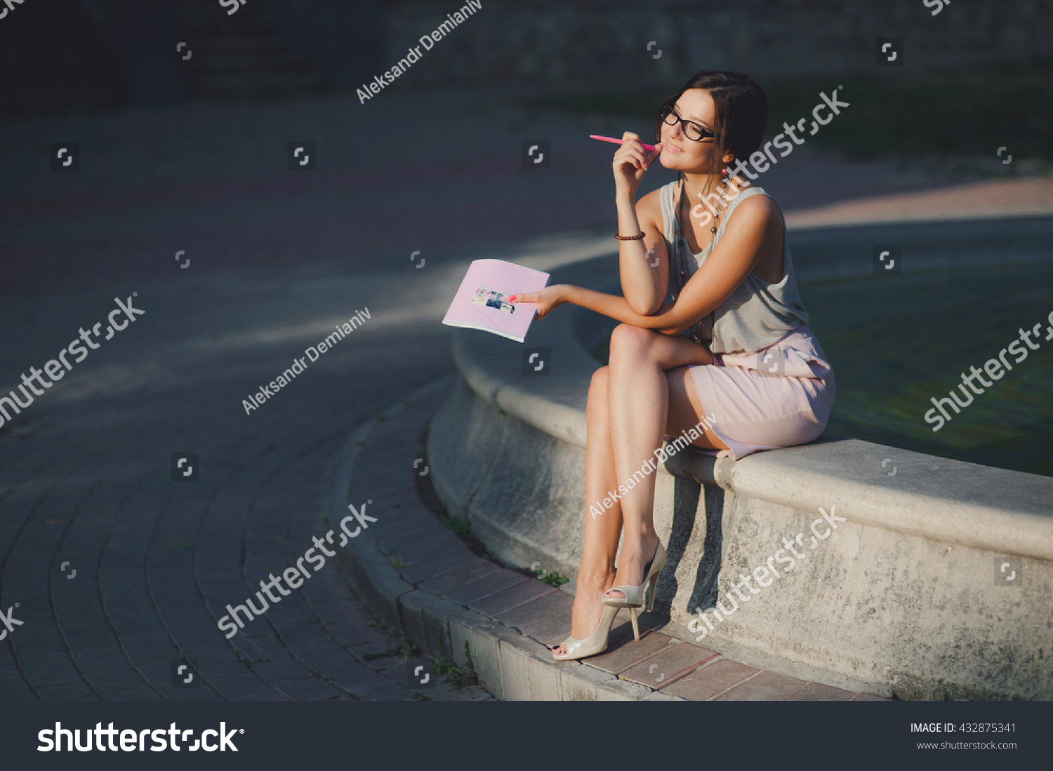 https://image.shutterstock.com/z/stock-photo-young-sun-burnt-lady-with-a-notebook-summer-evening-sunset-432875341.jpg