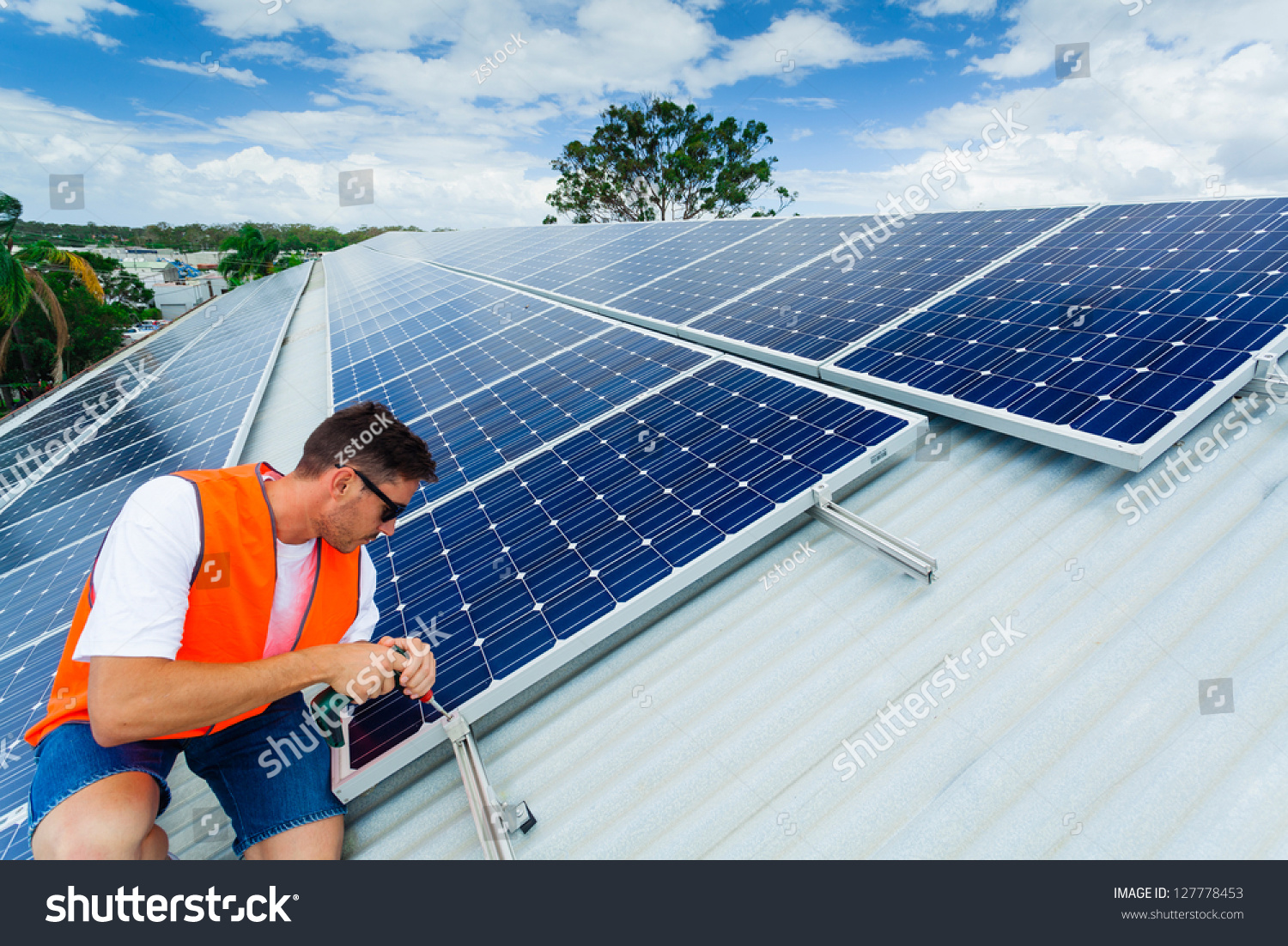 Young Technician Installing Solar Panels On Factory Roof Stock Photo 