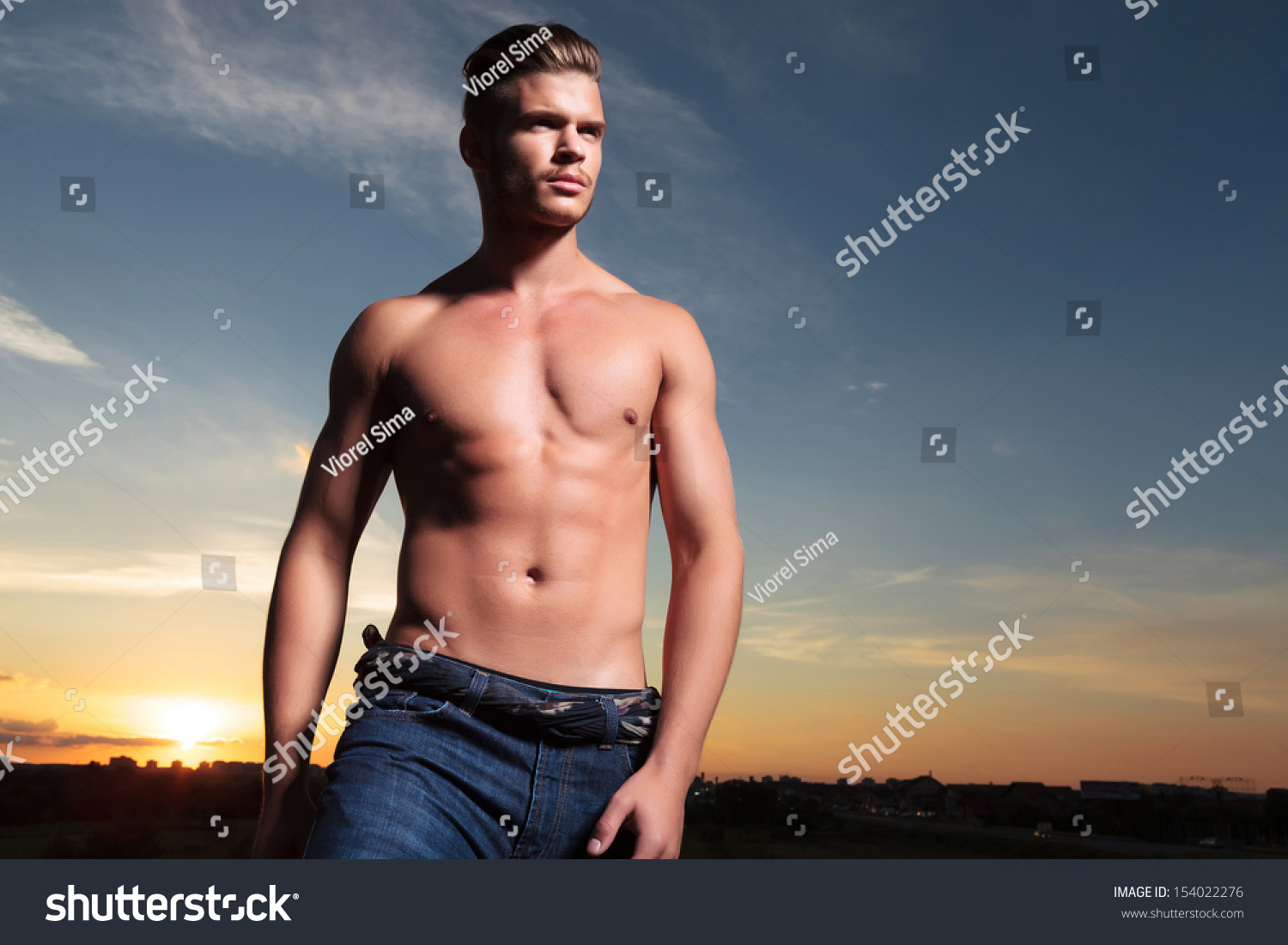 Young Topless Man Outdoor Looking Away With The Sunset Behind Stock ...