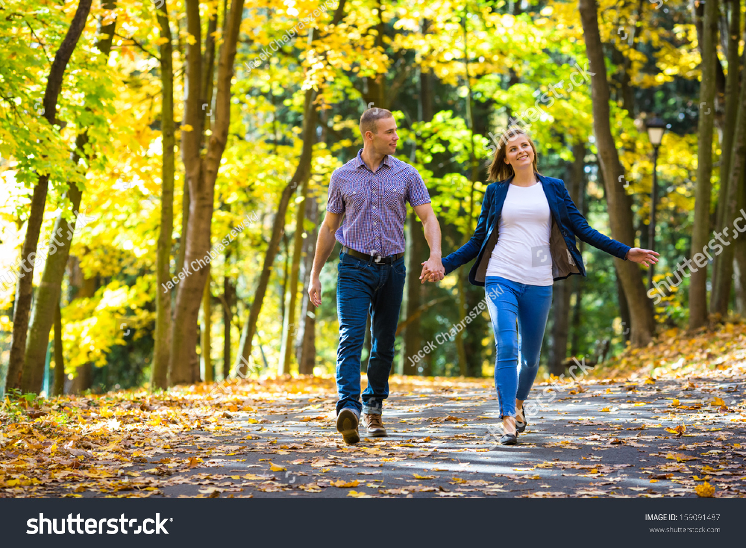 http://image.shutterstock.com/z/stock-photo-young-woman-and-man-walking-in-city-park-holding-hands-159091487.jpg