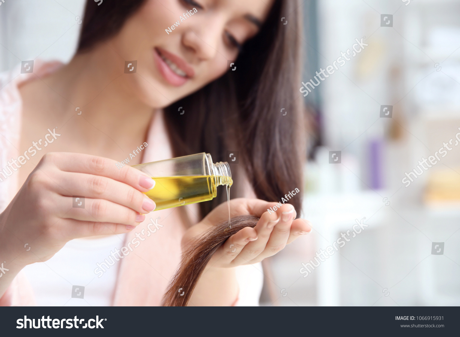 Stock Photo Young Woman Applying Oil Onto Hair At Home 1066915931 