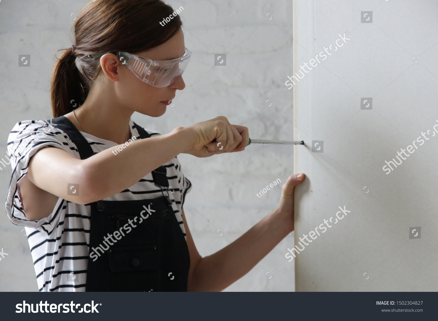 Young Woman Drilling Screws Into Plasterboard Stock Photo Edit