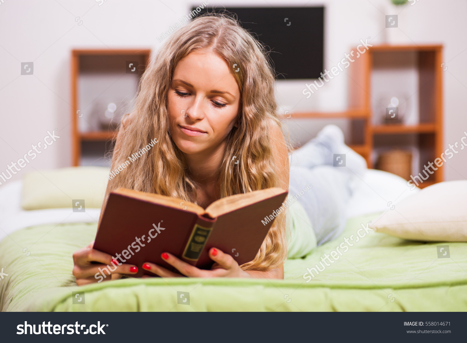 Young Woman Lying Bed Reading Book Stock Photo (Edit Now) 558014671