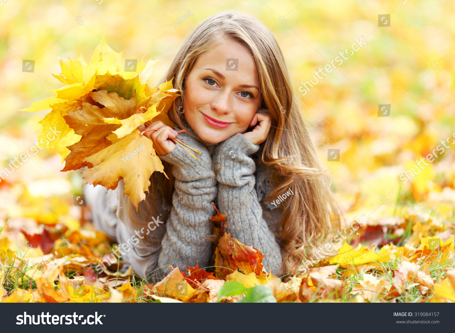 Young Woman Laying Down On The Ground In Autumn Park Stock Photo ...