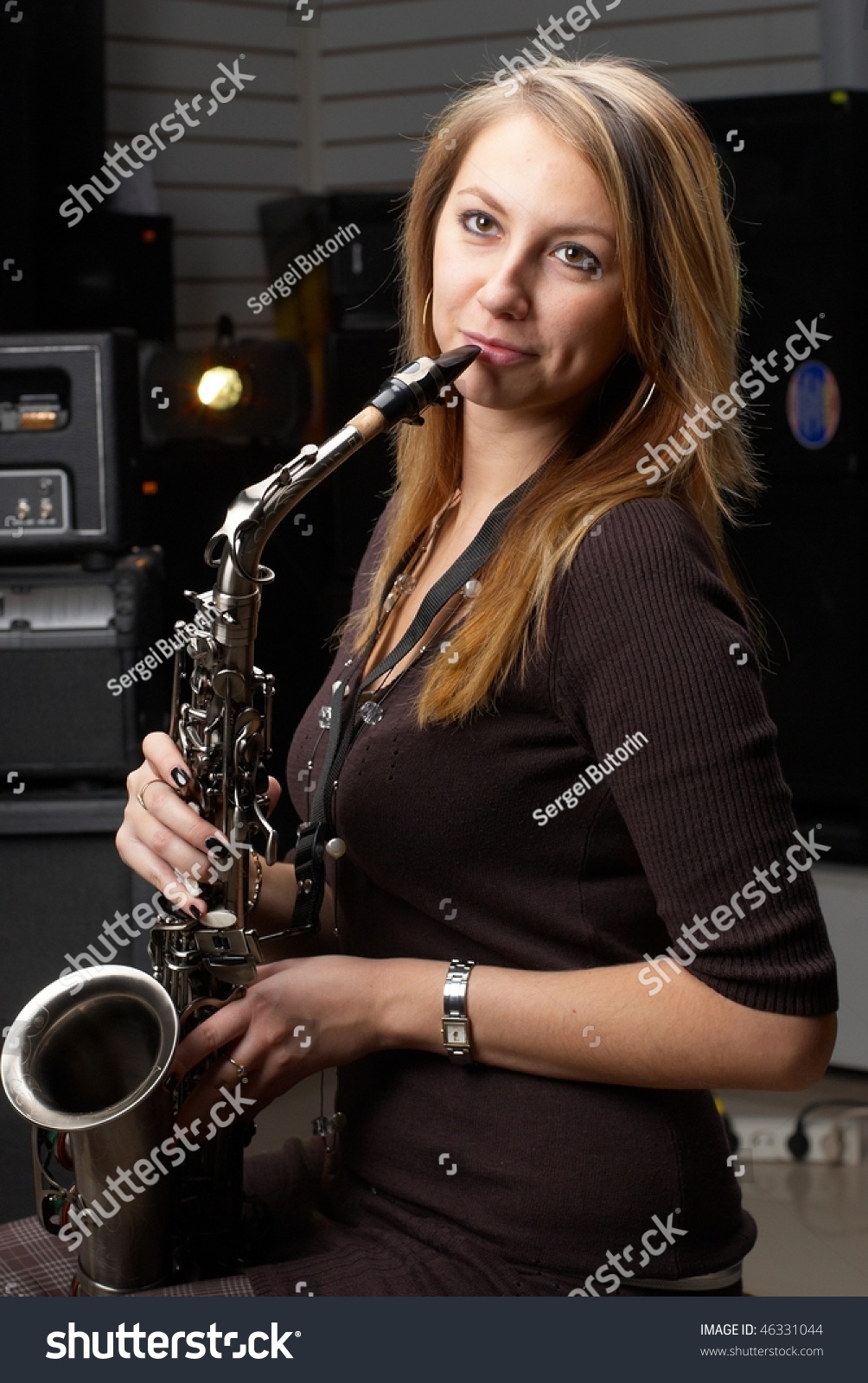 Young Woman Playing On Saxophone In Entertainment Club Stock Photo ...