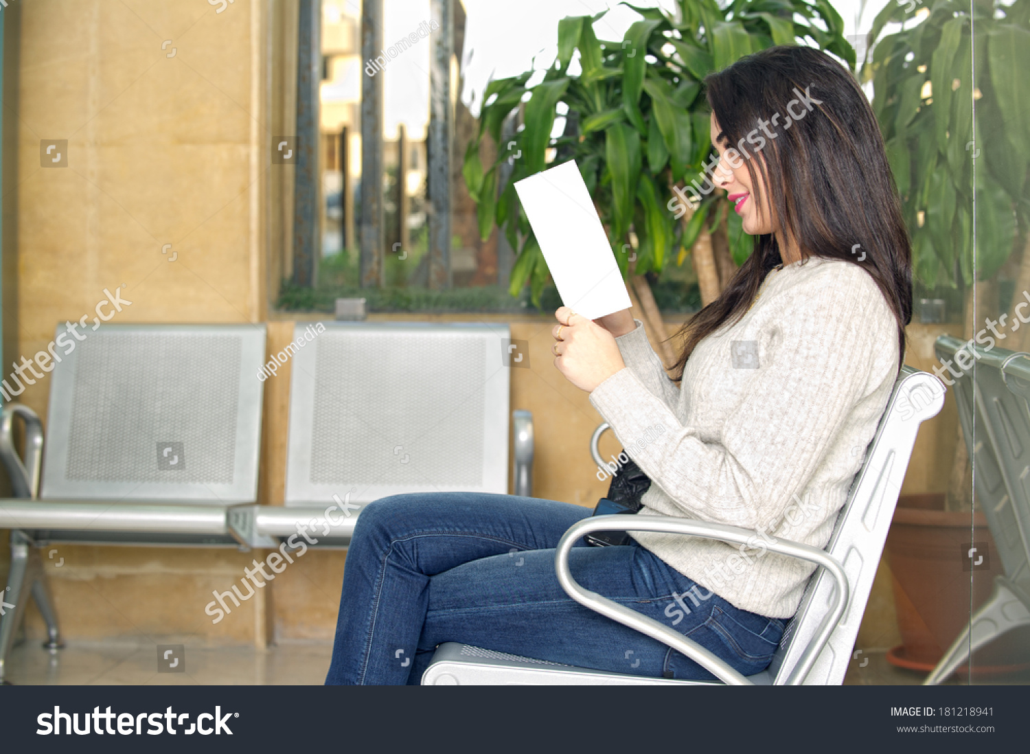 Young Woman Reading Brochure Doctors Waiting Stock Photo