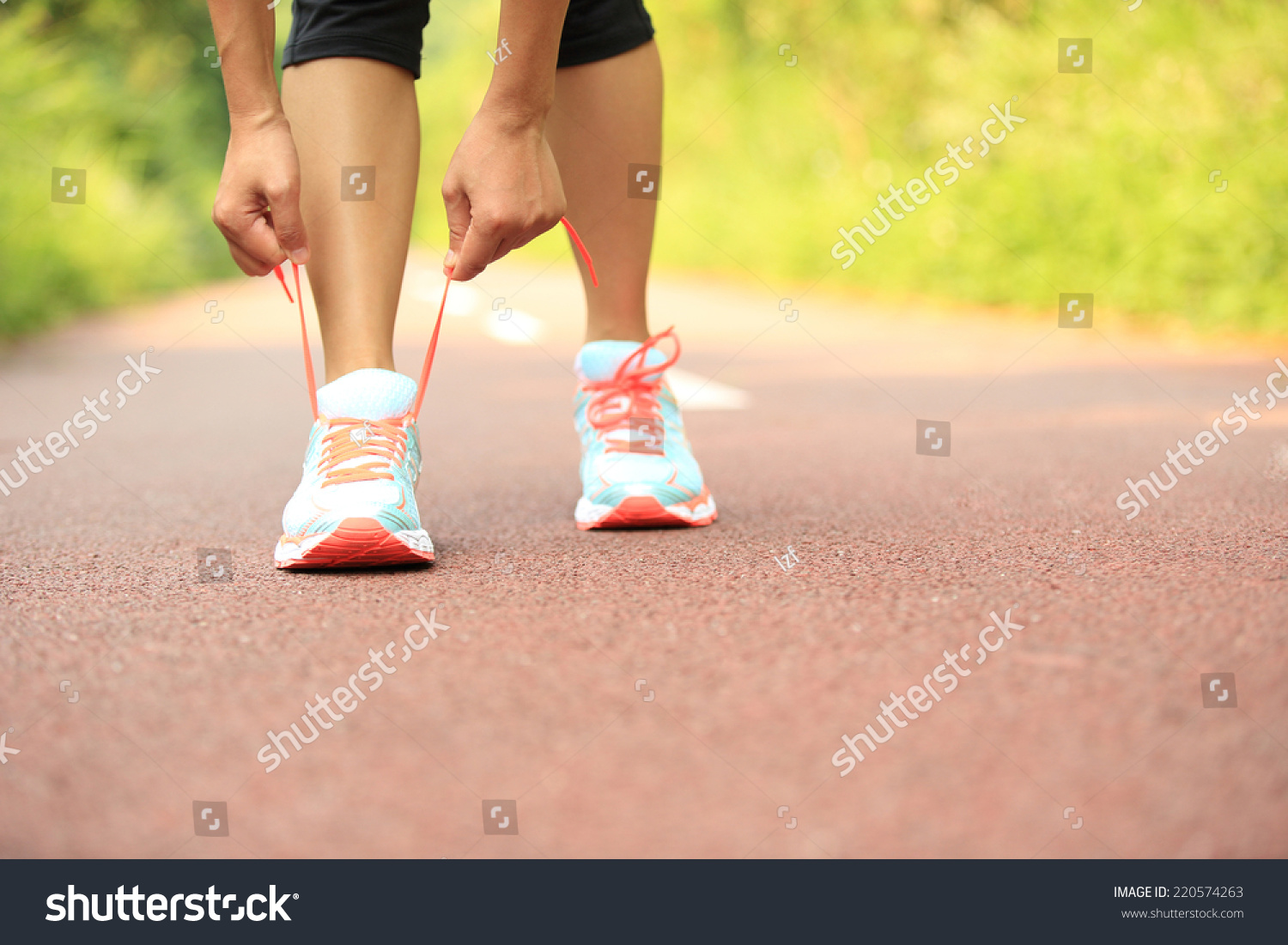 Young Woman Runner Tying Shoelaces Stock Photo (Edit Now) 220574263