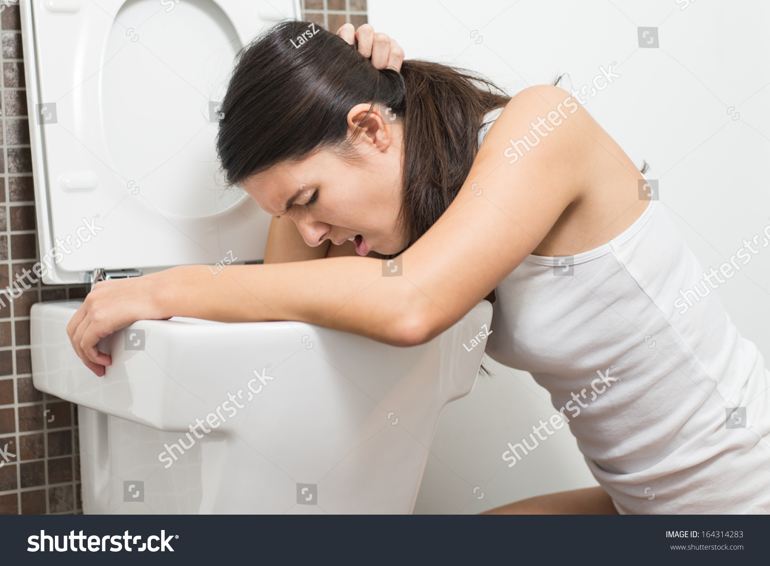 Young Woman Vomiting Into Toilet Bowl Stock Photo - Image 